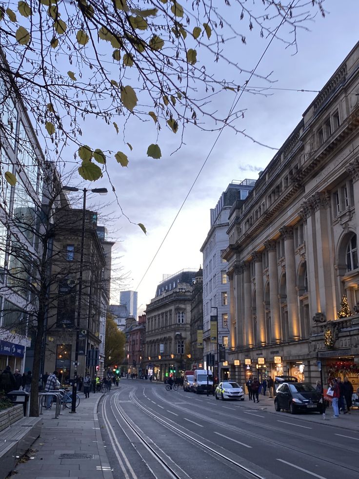 an empty city street with cars parked on both sides