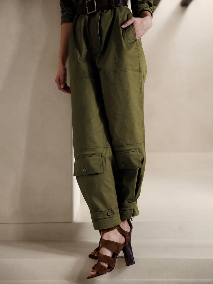 Ready for adventure, this utilitarian jumpsuit takes inspiration from archival styles with reinforced panels at the knees, topstitch detailing, pockets at the shins and a luxurious-yet-sturdy twill fabric of cotton, enhanced with a touch of stretch f Utility Parachute Pants With Flap Pockets For Outdoor, Outdoor Utility Parachute Pants With Flap Pockets, Spring Utility Cargo Pants, Spring Outdoor Cargo Pants With Patch Pockets, Spring Utility Cargo Pants For Workwear, Utility Cargo Pants For Spring Workwear, Military Cargo Pants With Multiple Pockets For Spring, Spring Military Style Parachute Pants With Cargo Pockets, Spring Military Parachute Pants With Cargo Pockets