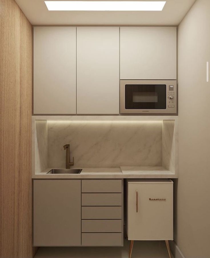 a kitchen with white cabinets and a microwave