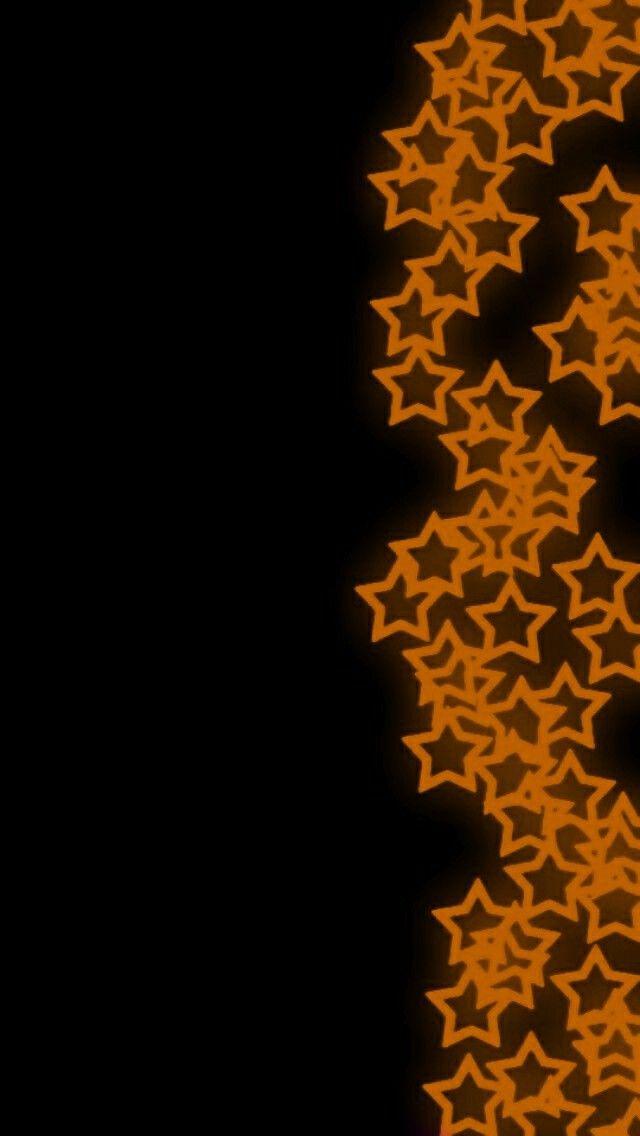 an orange and black background with many stars