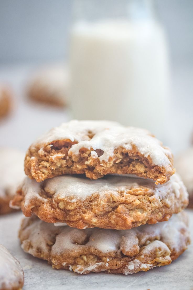 two cookies stacked on top of each other next to a glass of milk