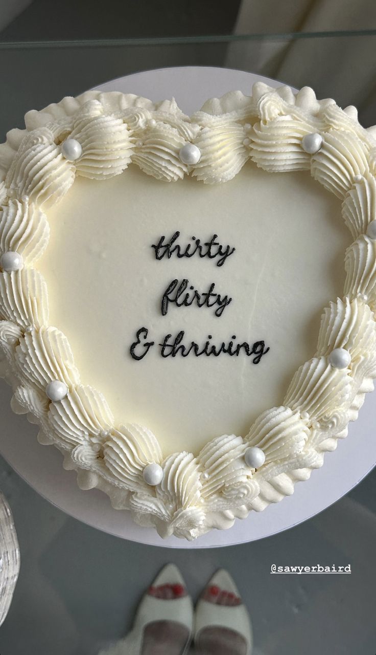 a heart shaped cake with the words thirty forty and thriving written on it