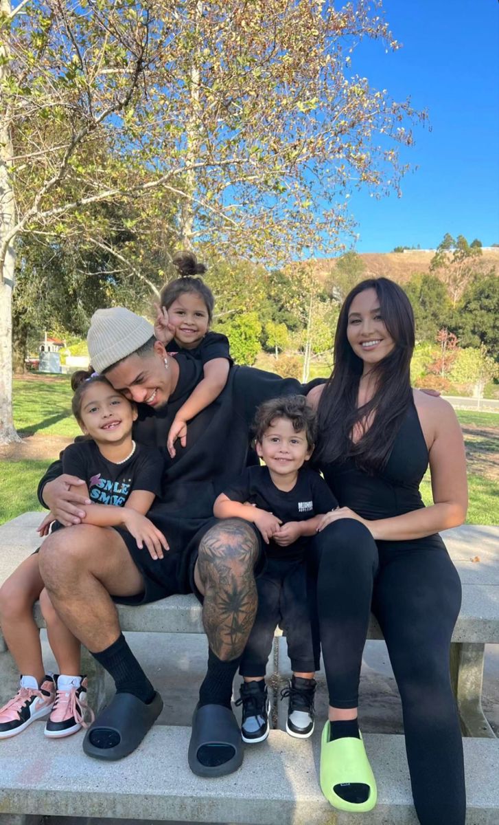 a family sitting on a bench in the park