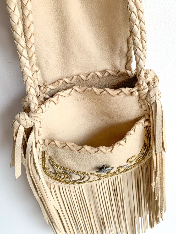 Unused pearl and bead embellished, fringed Ralph Lauren cross body purse in cream deerskin leather. High-end quality. 7"(w) x 7" (with fringe 15")h x 1.75"(d) Strap drop 25" Condition: Excellent. Note: Ralph Lauren 2011 Spring Collection invitation & book not included. Pink Fringe Bag, Beaded Leather Bag, Runway Bags, Ralph Lauren Western, Leather Handbag Patterns, Curated Closet, Country Fashion Women, Cowhide Bag, Fringe Purse