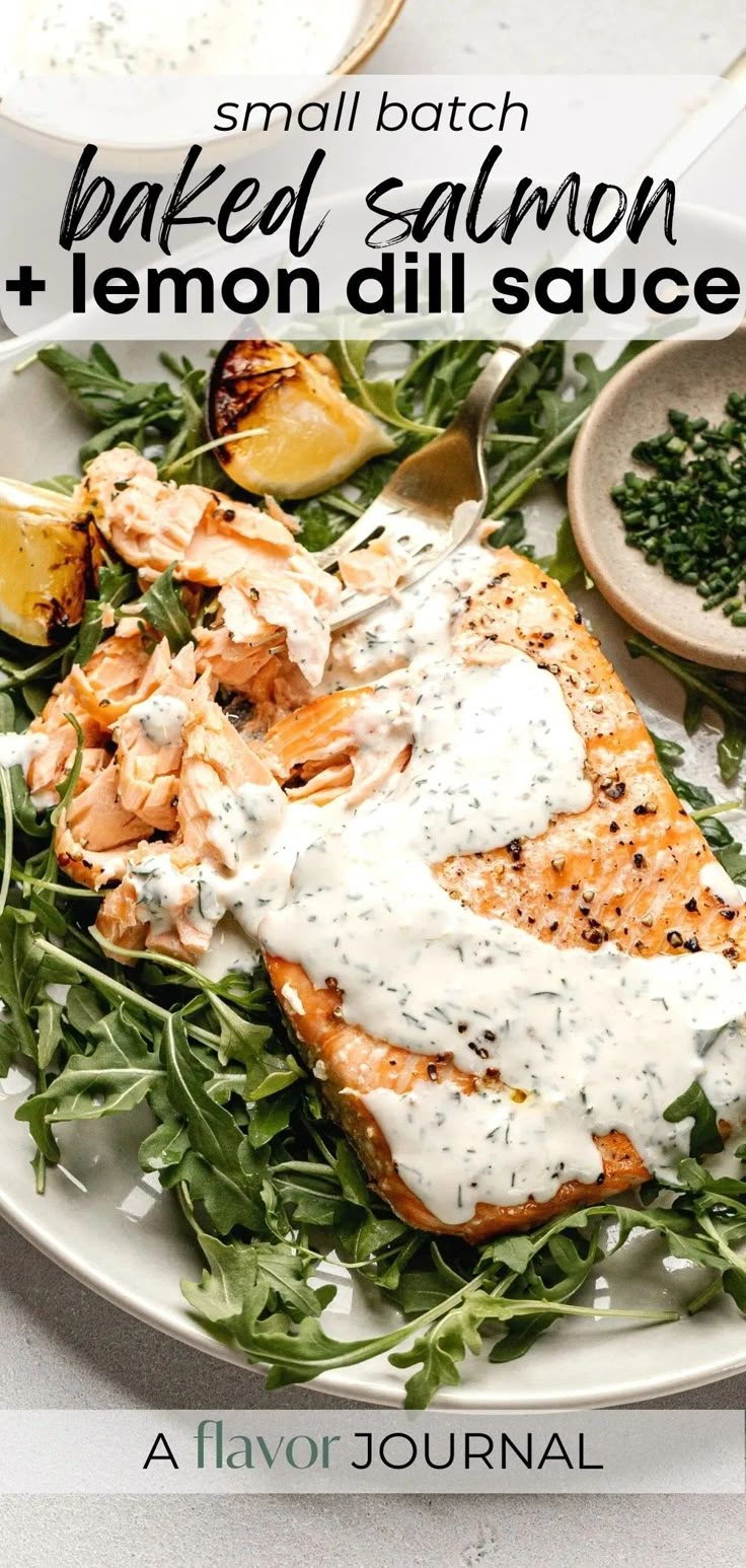 salmon and lemon dill sauce on a white plate with green garnishes