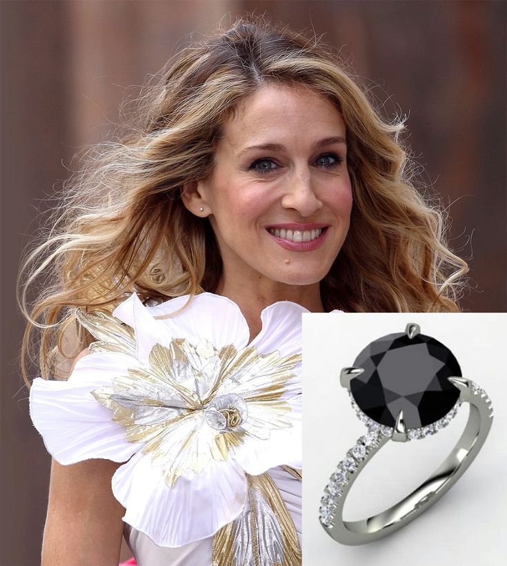 a woman wearing a ring with a flower on it and an image of a black diamond