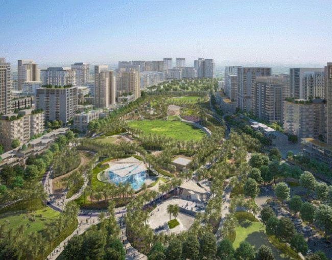 an aerial view of a city with lots of tall buildings and lush green park in the foreground