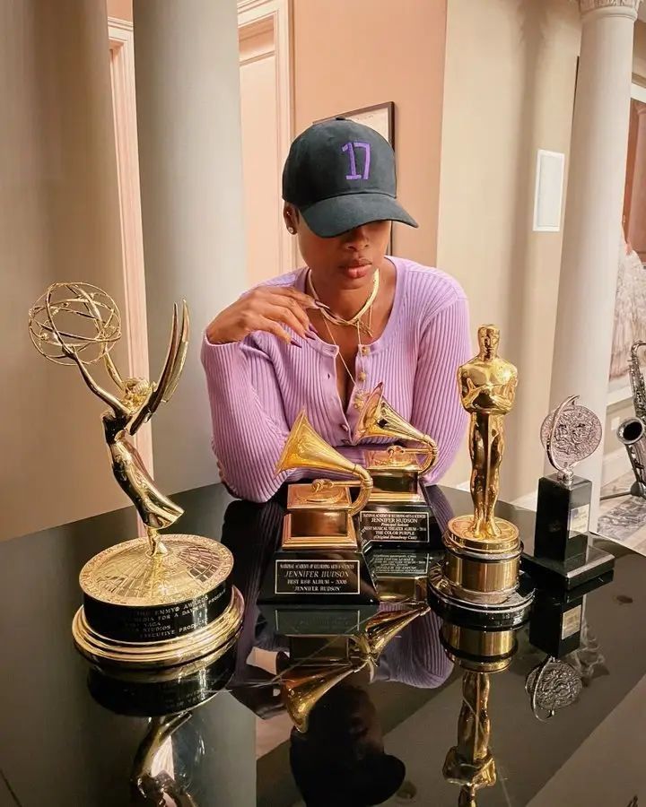 a person sitting at a table with trophies