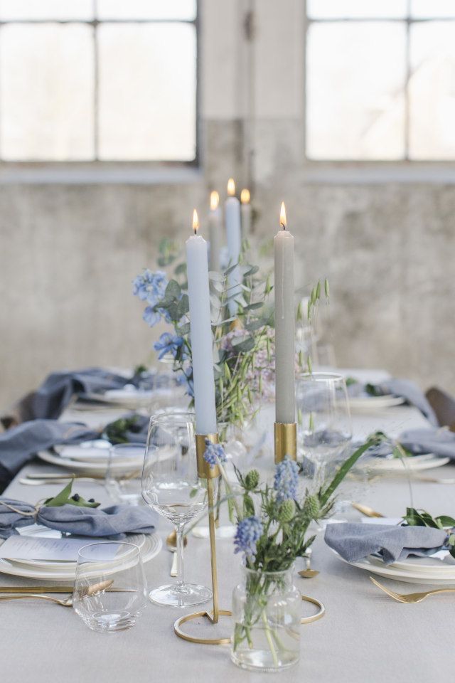 the table is set with candles and plates