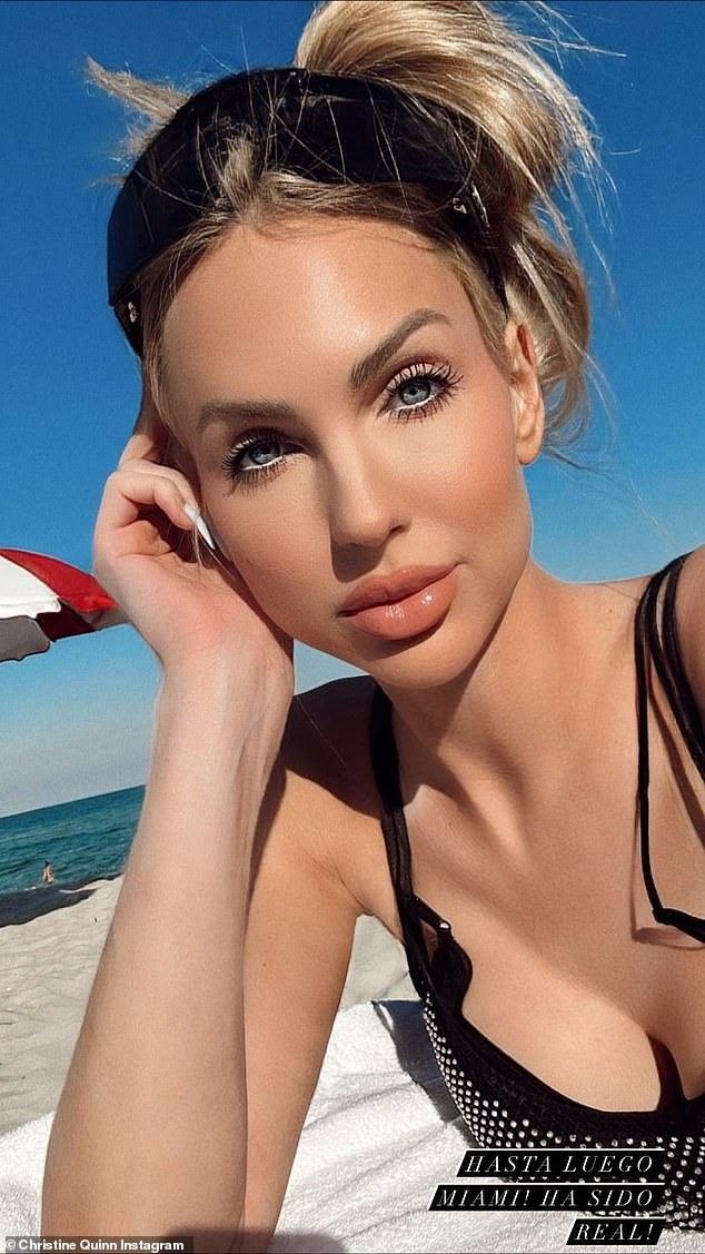 a beautiful woman sitting on top of a sandy beach