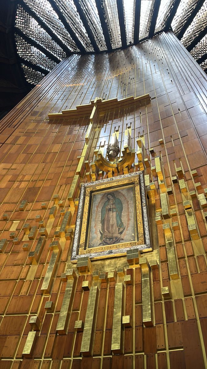 an ornate painting on the side of a tall building with gold and silver squares around it