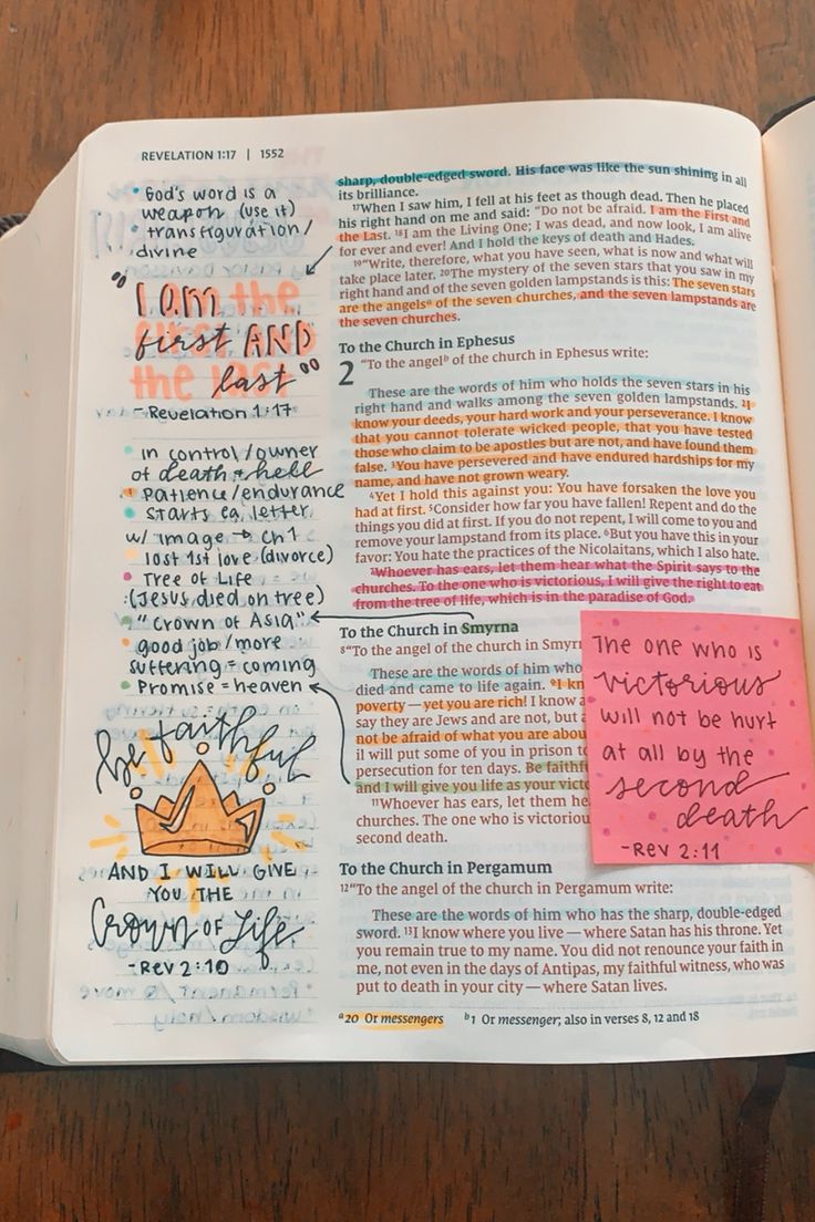 an open bible with writing on it and sticky notes attached to the book's pages