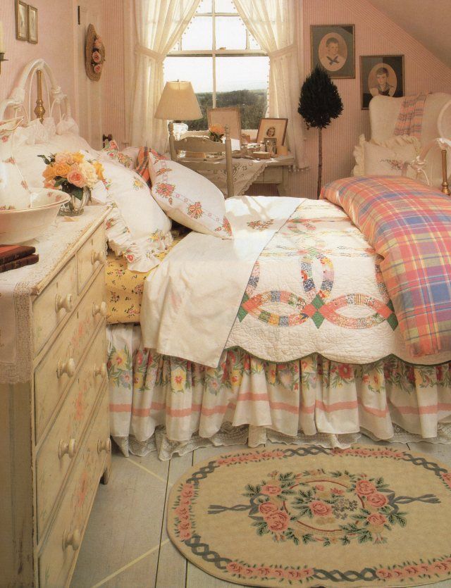 a bed room with a neatly made bed next to a dresser and a large window