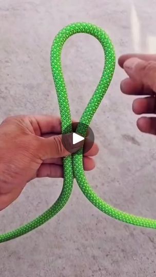 two hands are holding a green rope