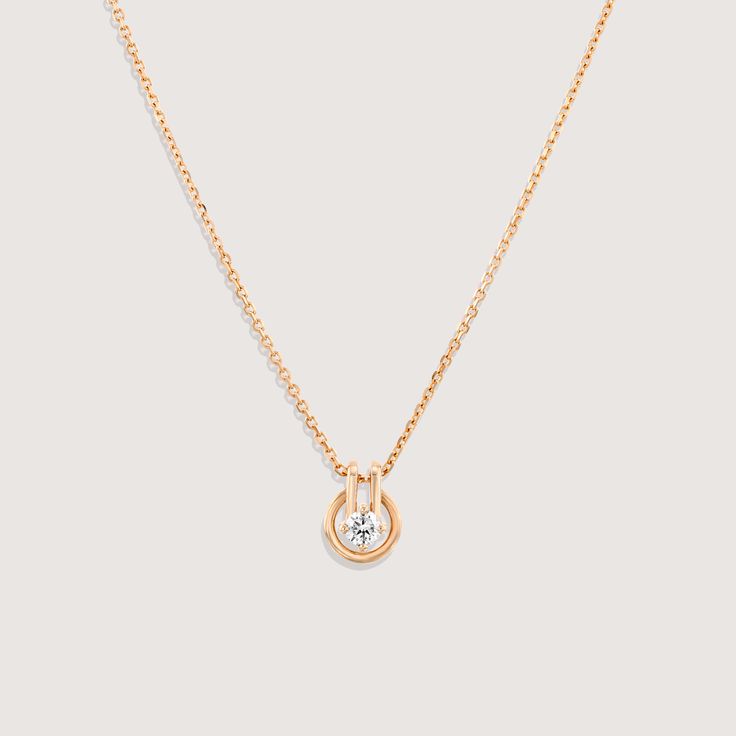 A fine chain leads to a circular gold pendant, with a diamond at the center. Inspired by the gold buttons that decorated suits in the 80s and 90s, we wanted to bring this moment back through one of our necklaces. Although overlooked often, buttons have played an integral role in fashion, whether advancing in practicality or as ornate details. We made sure that this piece was able to move along the chain like buttons do up and set free. If ordered in rose gold, the chain will be our Rollo chain. Formal Solitaire Necklace With Delicate Chain And Round Pendant, Elegant Oval Pendant Necklace With Bezel Setting, Formal Diamond Round Pendant Necklace, Timeless 14k Gold Formal Necklace, Dainty Round Pendant Necklace For Formal Occasions, Timeless Formal Necklaces With Delicate Chain, Formal Rose Gold Necklace With Detachable Pendant, Timeless Formal Necklace With Delicate Chain, Formal White Gold Diamond Necklace With Detachable Pendant