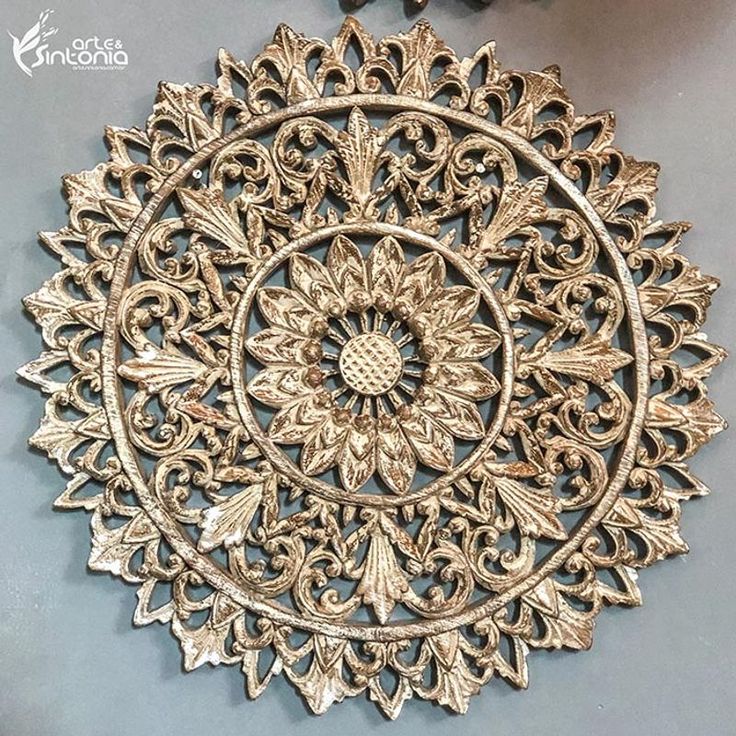 an ornate metal wall hanging on the wall