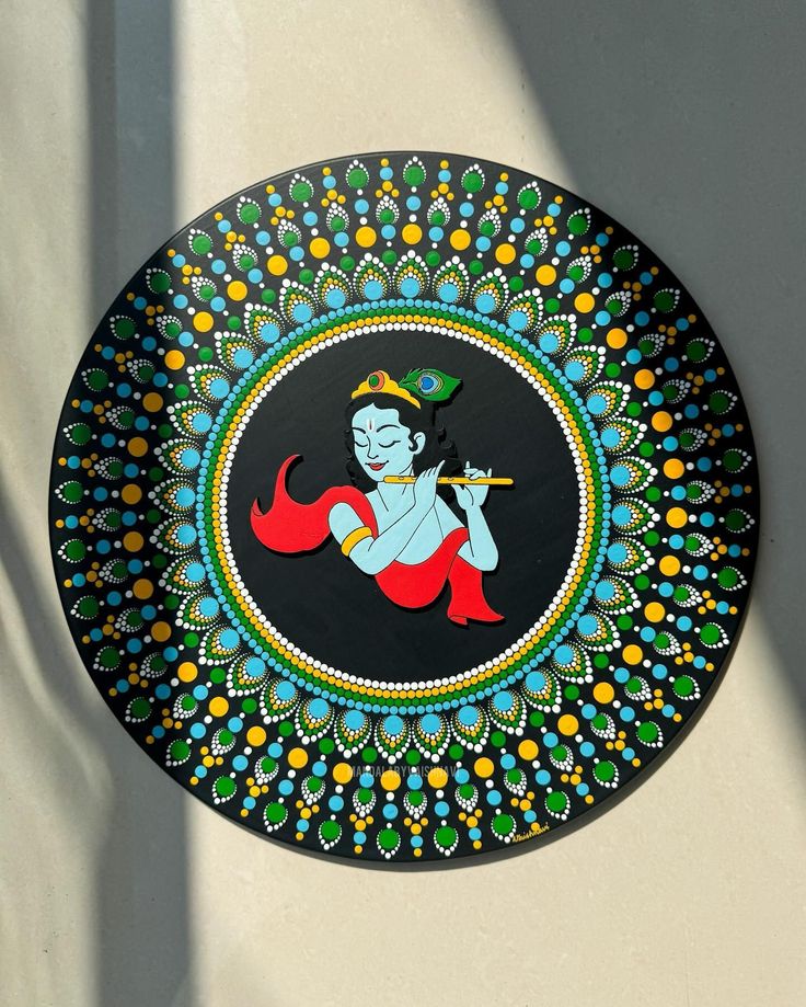 a decorative plate with an image of a hindu god on it