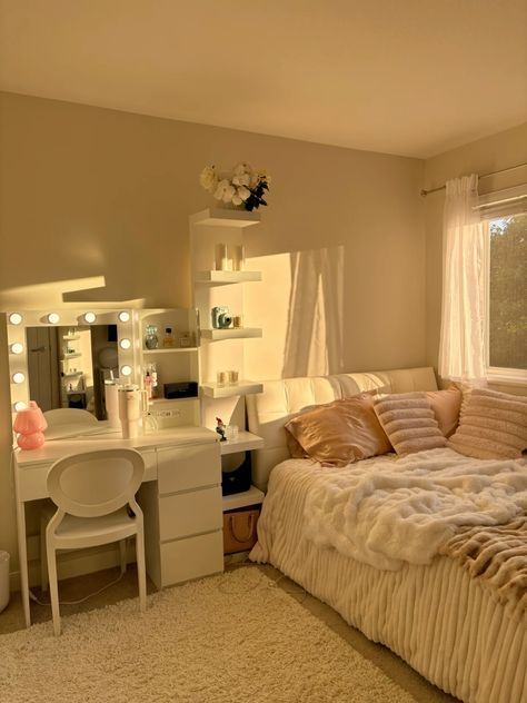 a bedroom with a bed, desk and vanity in it's corner area next to a window