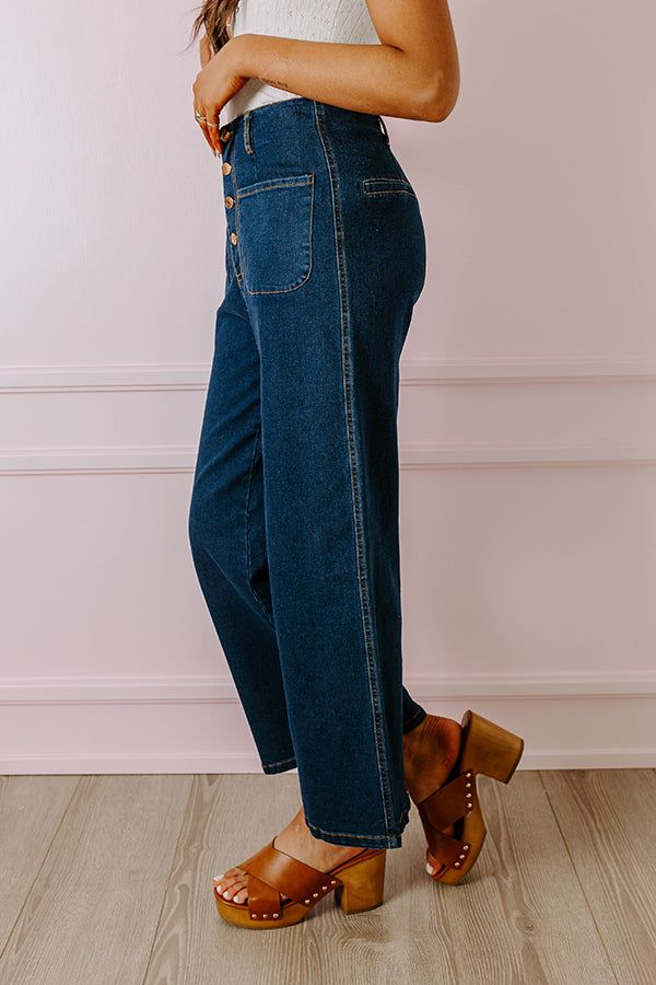 - We love a unique denim option like these trendy jeans! - Unlined semi-stretch denim material - A high waistline with belt loops and four button closure - Two functional front pockets - Two faux pocket cut accents on the back - A relaxed yet flattering silhouette that ends in wide ankle length hemlines Dark Wash Cropped Jeans With Button Closure For Spring, Dark Wash Cropped Jeans For Spring, Casual Flare Jeans For Work With Buttons, Casual Flare Jeans For Work, Everyday Dark Wash Denim Bottoms, Medium Wash Jeans For Work With Button Closure, Chic Dark Wash Bottoms With Buttons, High Waist Cropped Jeans With Button Closure For Fall, Trendy Workwear Jeans