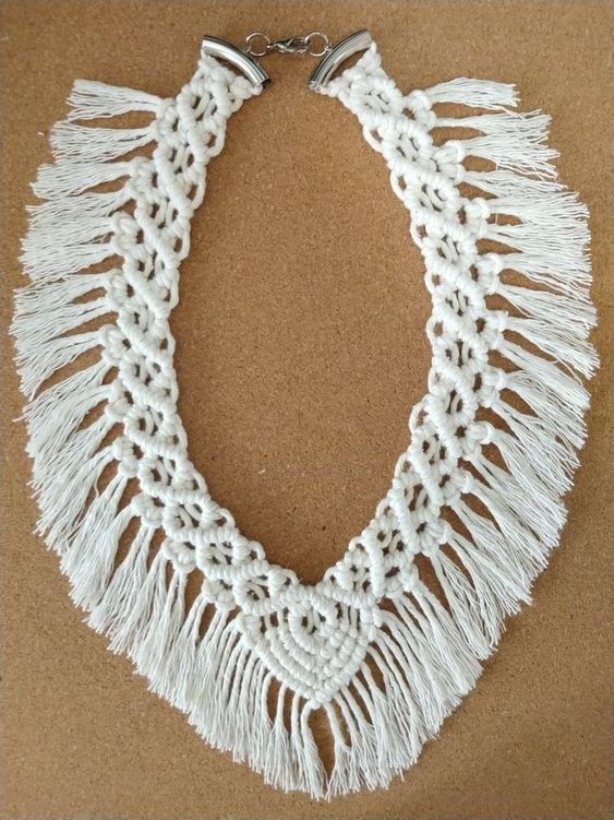 a white crocheted necklace with tassels