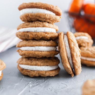 a stack of cookies sitting on top of a table next to some carrots and other food