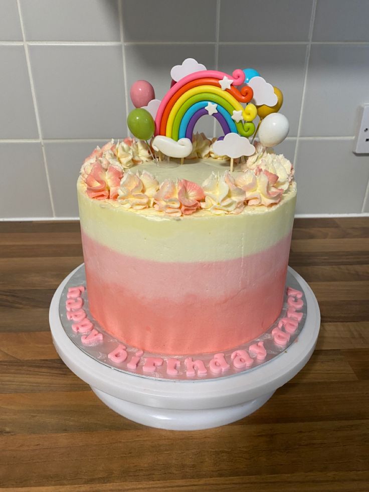 there is a cake that has been decorated with rainbows