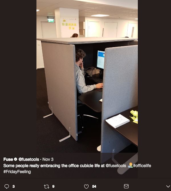 a man sitting at a desk in an office cubicle