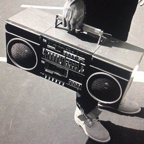 a person standing on top of a boom box