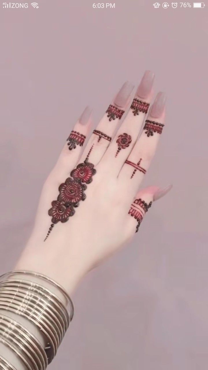 a woman's hand with henna tattoos on it