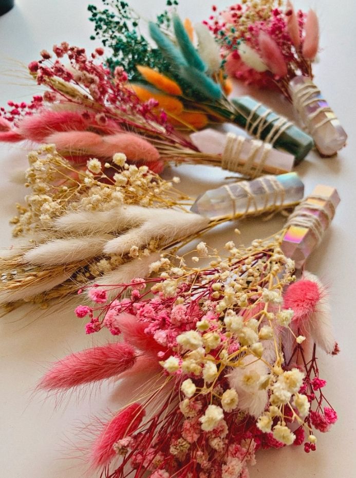 flowers and feathers are arranged on a table