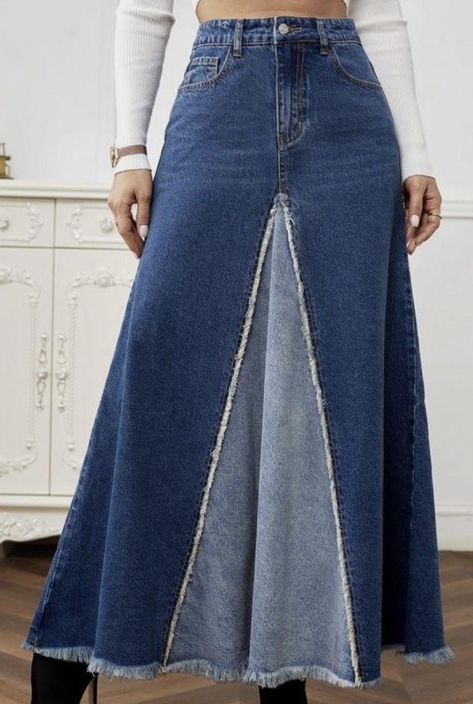 a woman in a white top is wearing a denim skirt with an asymmetrical design