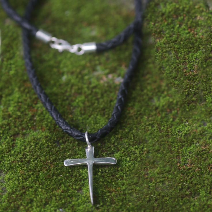 A cross shines with sterling splendor in a design by Nyoman Rena. The stylized cross pendant is crafted by hand and centers a leather braided cord. Sterling silver and leather Lobster claw clasp Handmade in Indonesia Paw Print Jewelry, Spirit Clothing, Ribbon Jewelry, Fair Trade Jewelry, Printed Jewelry, Yoga Bag, Sleep And Loungewear, Flip Flop Shoes, Reusable Grocery Bags