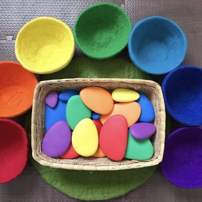 a basket filled with lots of different colored rocks