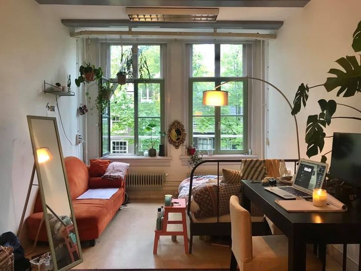 a living room filled with furniture and a flat screen tv sitting on top of a wooden table