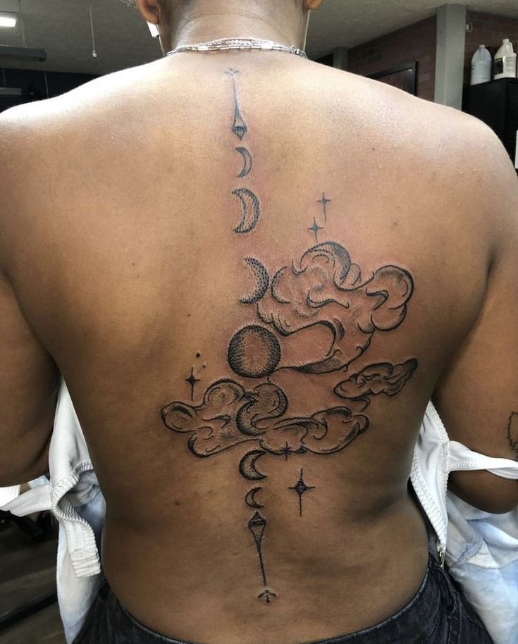 the back of a woman's upper body with clouds and stars on her left side