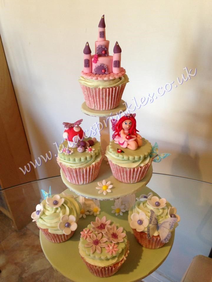 there are cupcakes that have been placed on top of the cake stand for display