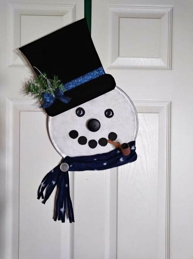 a snowman hat hanging on the front door