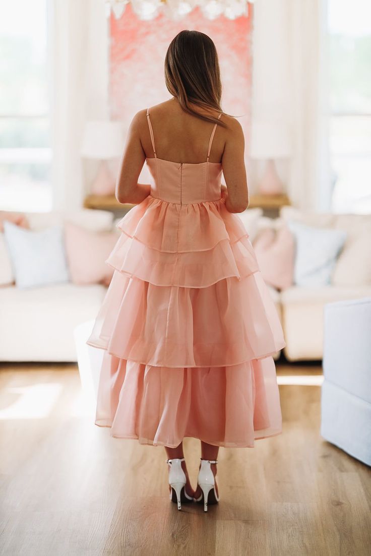 This ruffle layered midi dress is stunning! We love the boning in the top that makes it so flattering. Fit: True to size, model is 5'6 wearing size small Feminine Ruffle Hem Maxi Dress For Bridesmaids, Elegant Layered Spring Dresses, Spring Bridesmaid Ruffle Dress With Ruffle Hem, Spring Bridesmaid Ruffle Dress, Feminine Ruffled Maxi Dress For Bridesmaid, Summer Tea-length Midi Dress With Ruffles, Summer Bridesmaid Dress With Tiered Skirt, Sleeveless Layered Hem Dress For Garden Party, Bridesmaid Dresses With Ruffles And Tiered Skirt