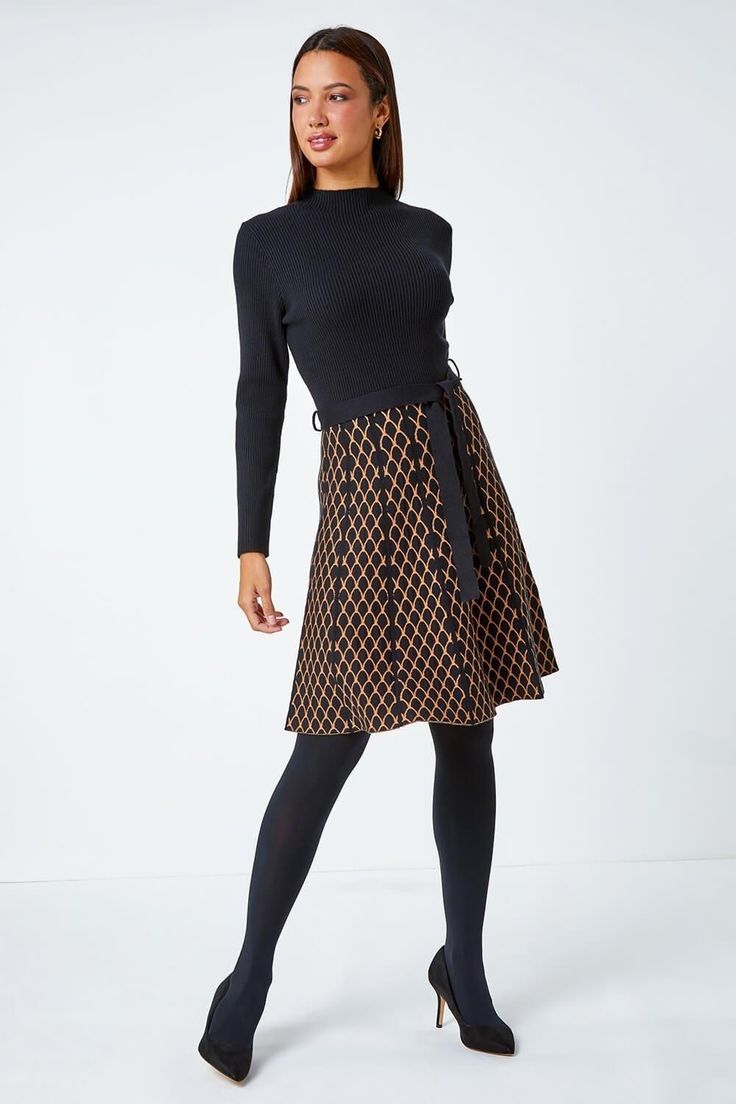 Contrast Skirt Knit Jacquard Dress from Roman. Perfect for the cooler season ahead, this contrast knit dress is crafted from a soft ribbed fabric. It features a cosy high neckline and long sleeves for a trendy finish. This dress is designed with a panelled, printed skirt which falls to an everyday knee-length in a flattering fit and flare style. Finished with a self-tie fabric belt, this is perfect paired with tights, boots and a fluffy gilet for an everyday Autumn look! Chic Fitted Pointelle Knit Skirt, Chic A-line Knit Dress, Black Skirted Dress For Fall, Flared Skirt Dresses For Work In Fall, Winter Fitted Dress With Flared Skirt, Black Lined Skirt Dress For Fall, Black Winter Dress With Lined Skirt, Black Winter Dresses With Lined Skirt, Black Lined Winter Dress