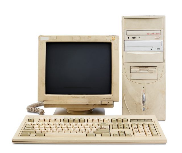 an old computer with a keyboard, mouse and monitor sitting next to each other on a white background