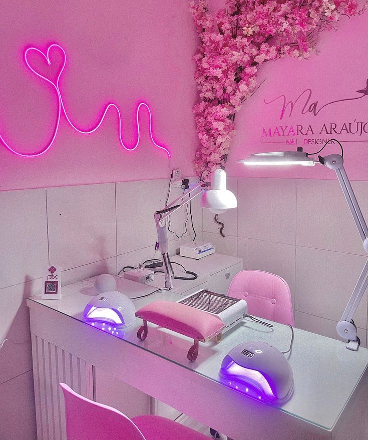 a pink room with flowers on the wall and a computer desk in front of it