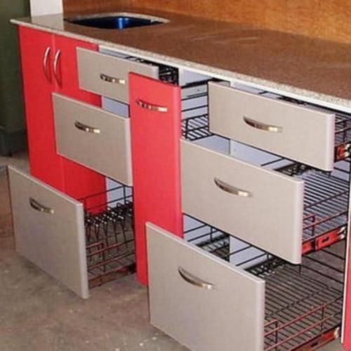 a kitchen island with drawers and baskets on it