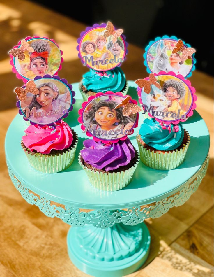 there are cupcakes that have been decorated with princesses on top of them