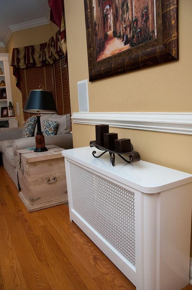 a living room with a white radiator next to a painting on the wall