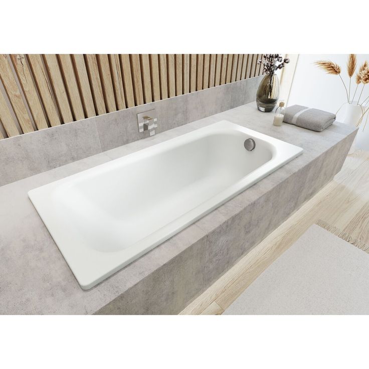 a white bath tub sitting on top of a bathroom counter