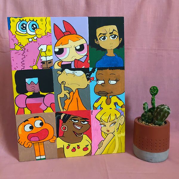 an art piece with cartoon characters on it next to a potted cacti