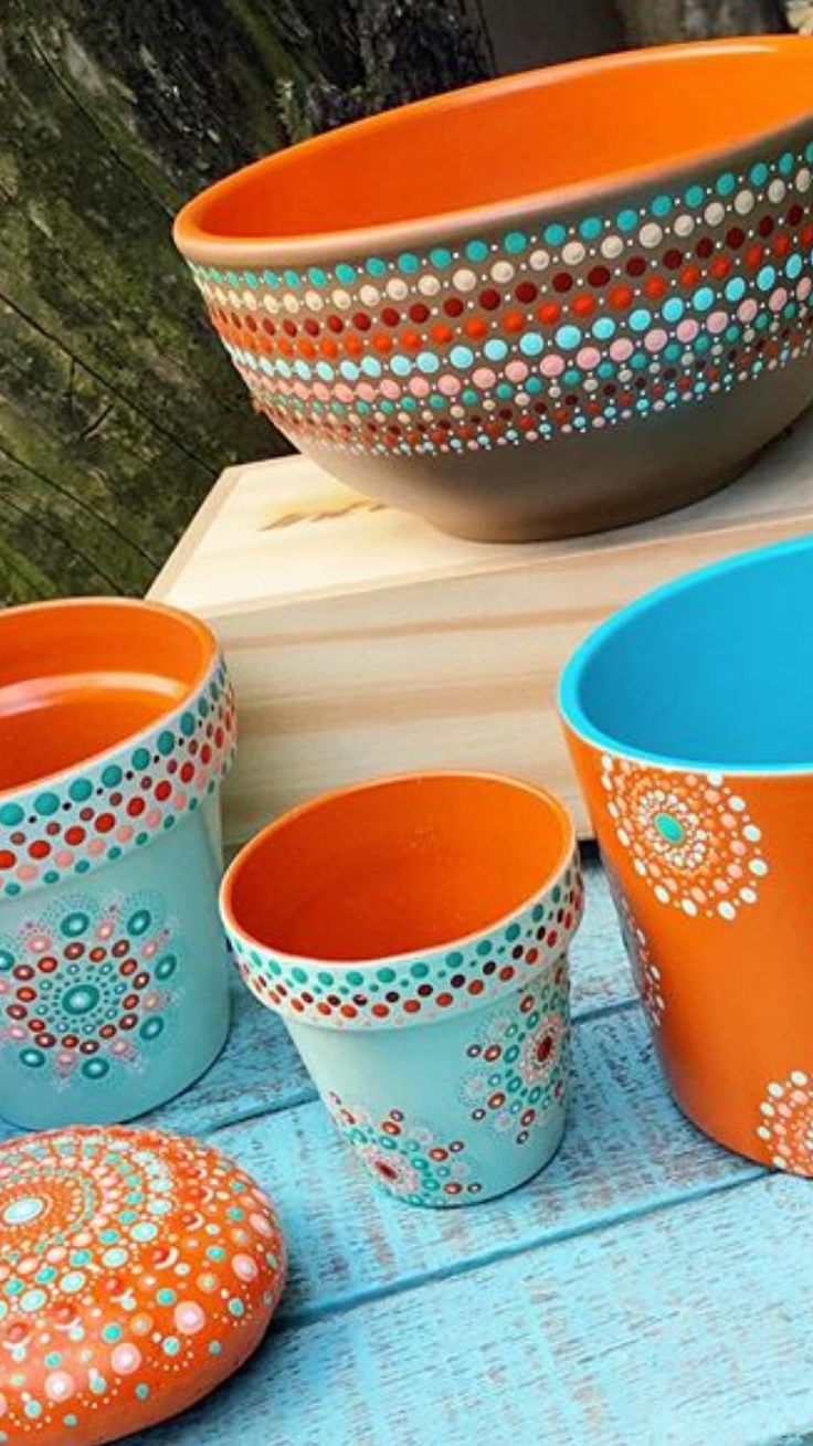 colorful bowls and plates are sitting on a table