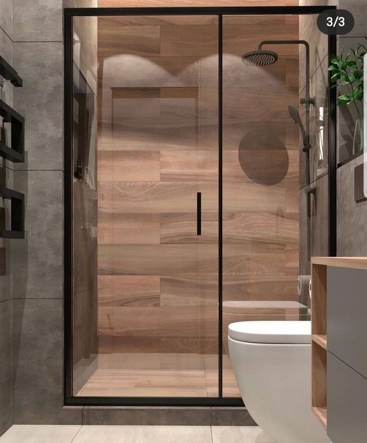 a bathroom with a toilet, sink and shower stall in the corner next to a wooden paneled wall