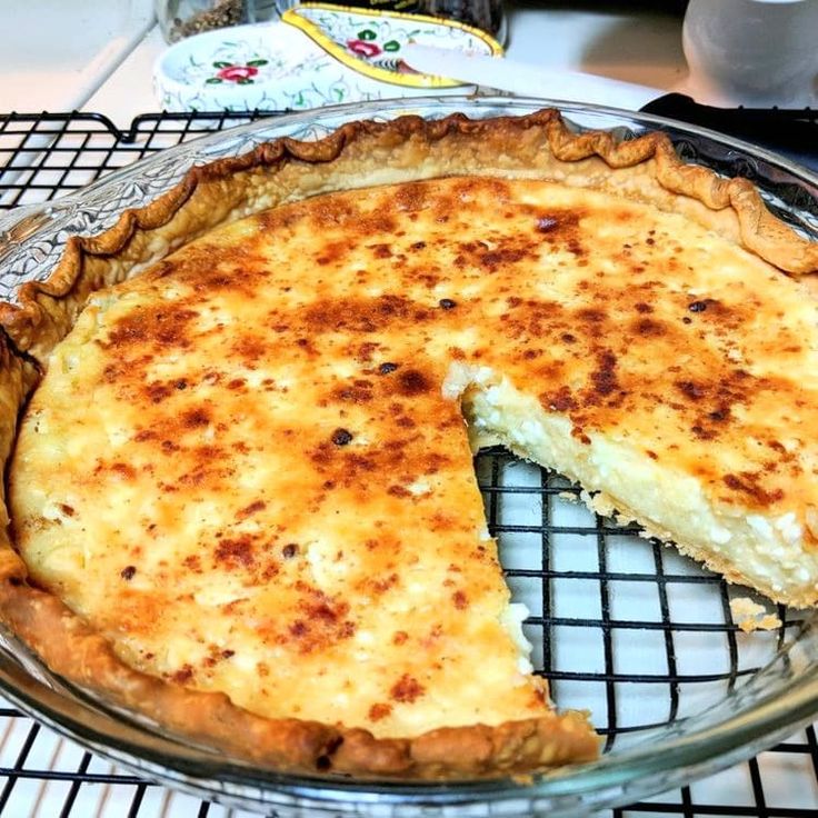 a cheese pie sitting on top of a cooling rack