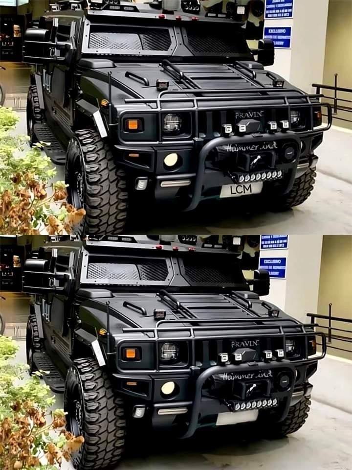 two black armored vehicles parked next to each other